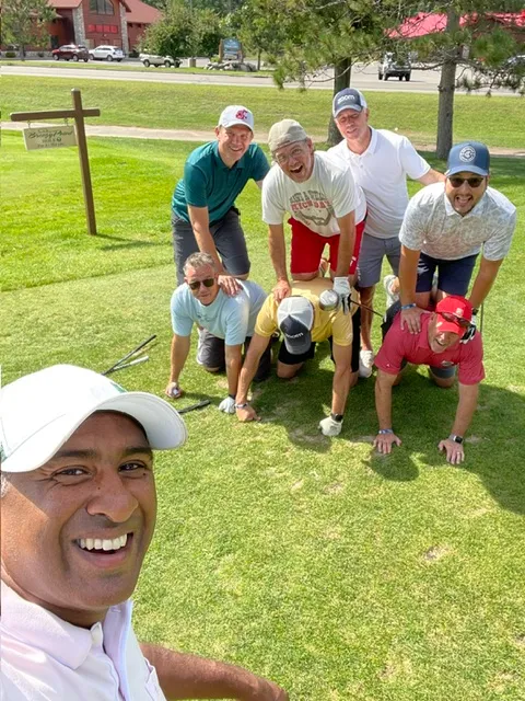 Golfers stacked in a pyramid on the fairway