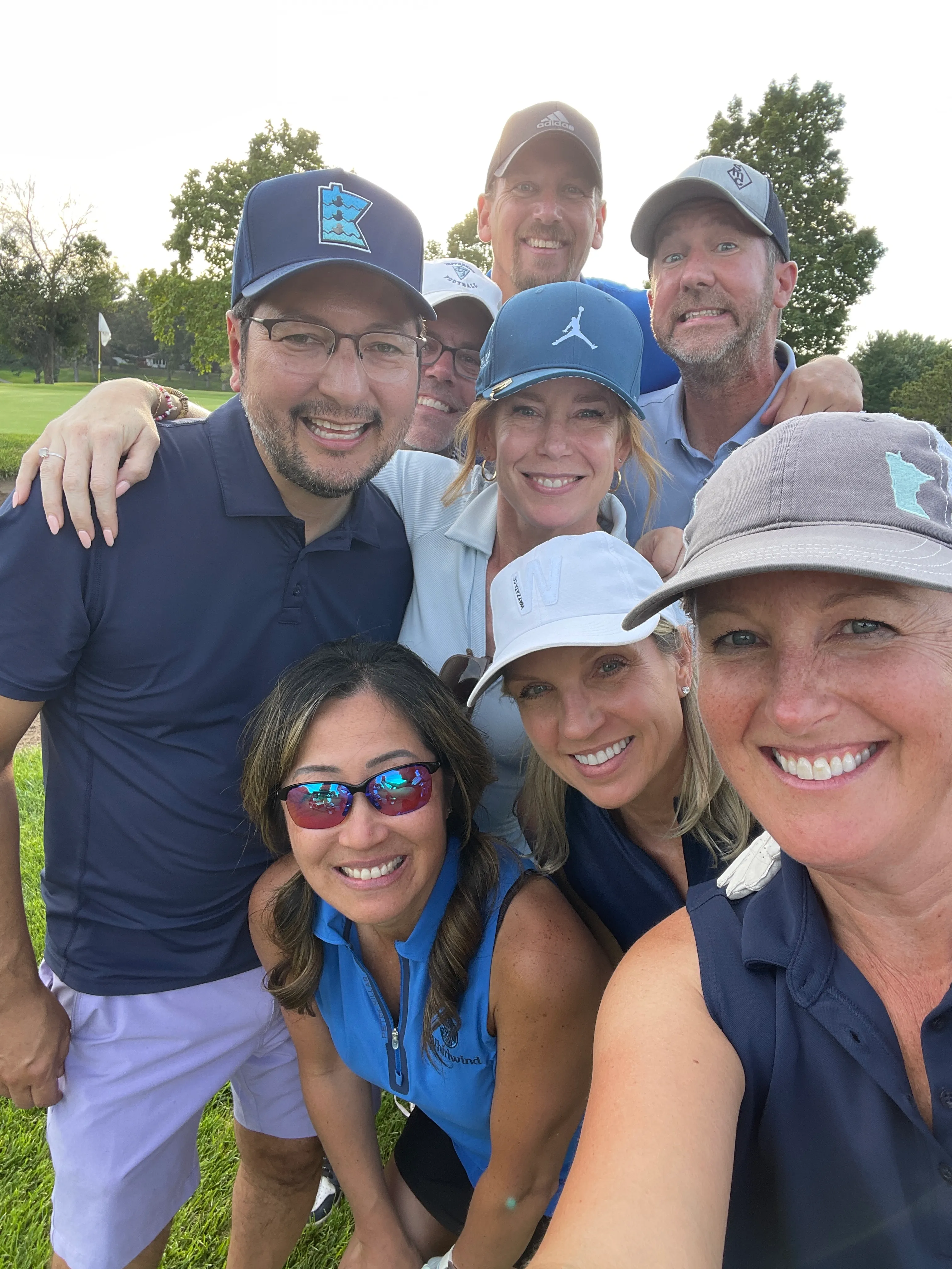 A mixed group of golfers on the course